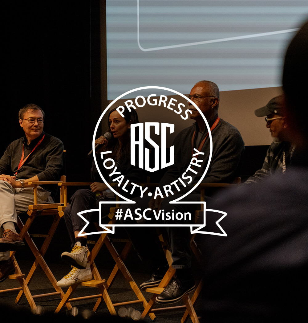 Expert Cinematographers sit in directors chairs and participate in a panel